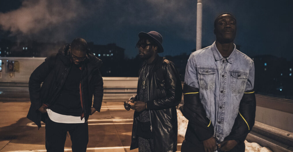 three young men posing outdoor looking camera three young men posing outdoor looking camera serious - rap crew, gang, swag concept